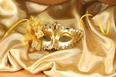 Beautifully decorated face mask on golden fabric. Theatrical performance