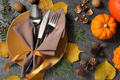 Happy Thanksgiving day. Beautiful table setting and autumn decoration on grey background, flat lay