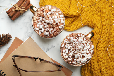 Photo of Cups of delicious hot cocoa with marshmallows on white marble table, flat lay