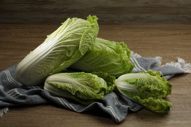 Photo of Fresh ripe Chinese cabbages on wooden table