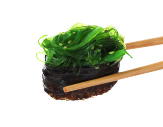 Photo of Chopsticks with seaweed sushi isolated on white