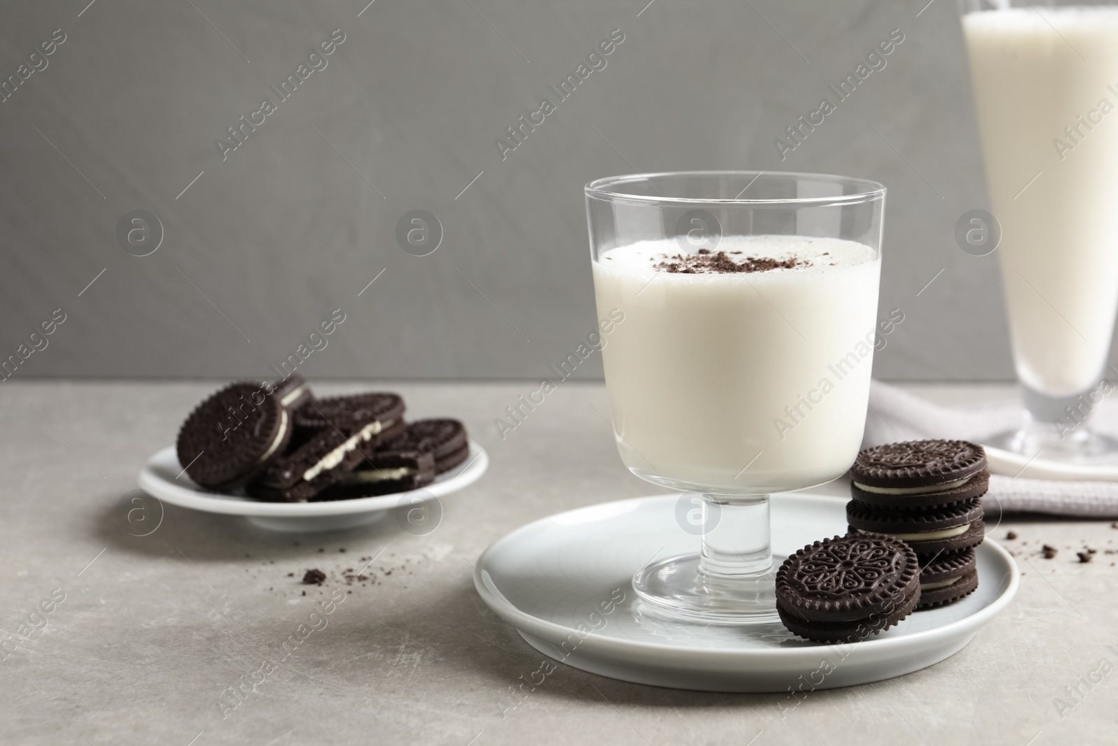 Photo of Glass with milk and chocolate cookies on table against grey background. Space for text