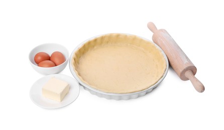 Photo of Quiche pan with fresh dough, rolling pin and ingredients isolated on white