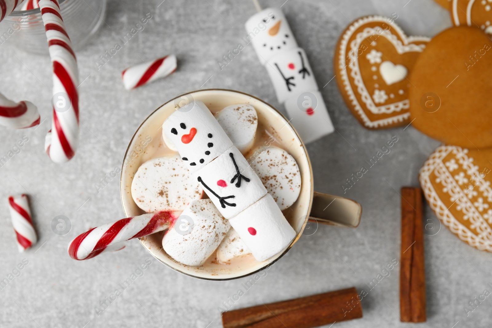 Photo of Flat lay composition with funny snowman made of marshmallows on grey table