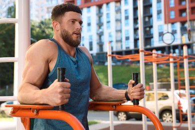 Photo of Man training on abs station at outdoor gym
