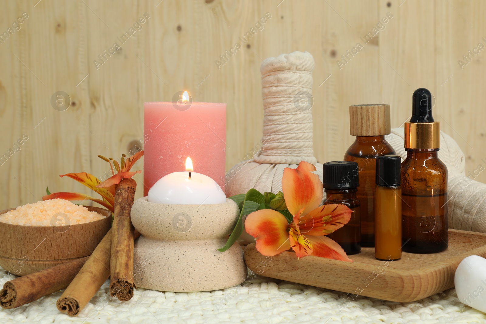 Photo of Different aromatherapy products and burning candles on table