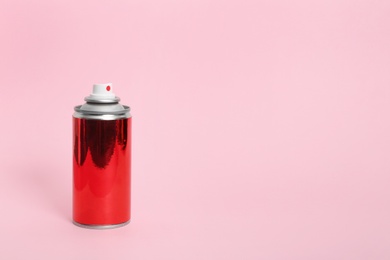 Can of spray paint on color background. Space for text