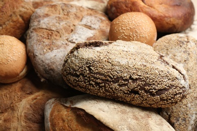 Different kinds of delicious bread as background, closeup