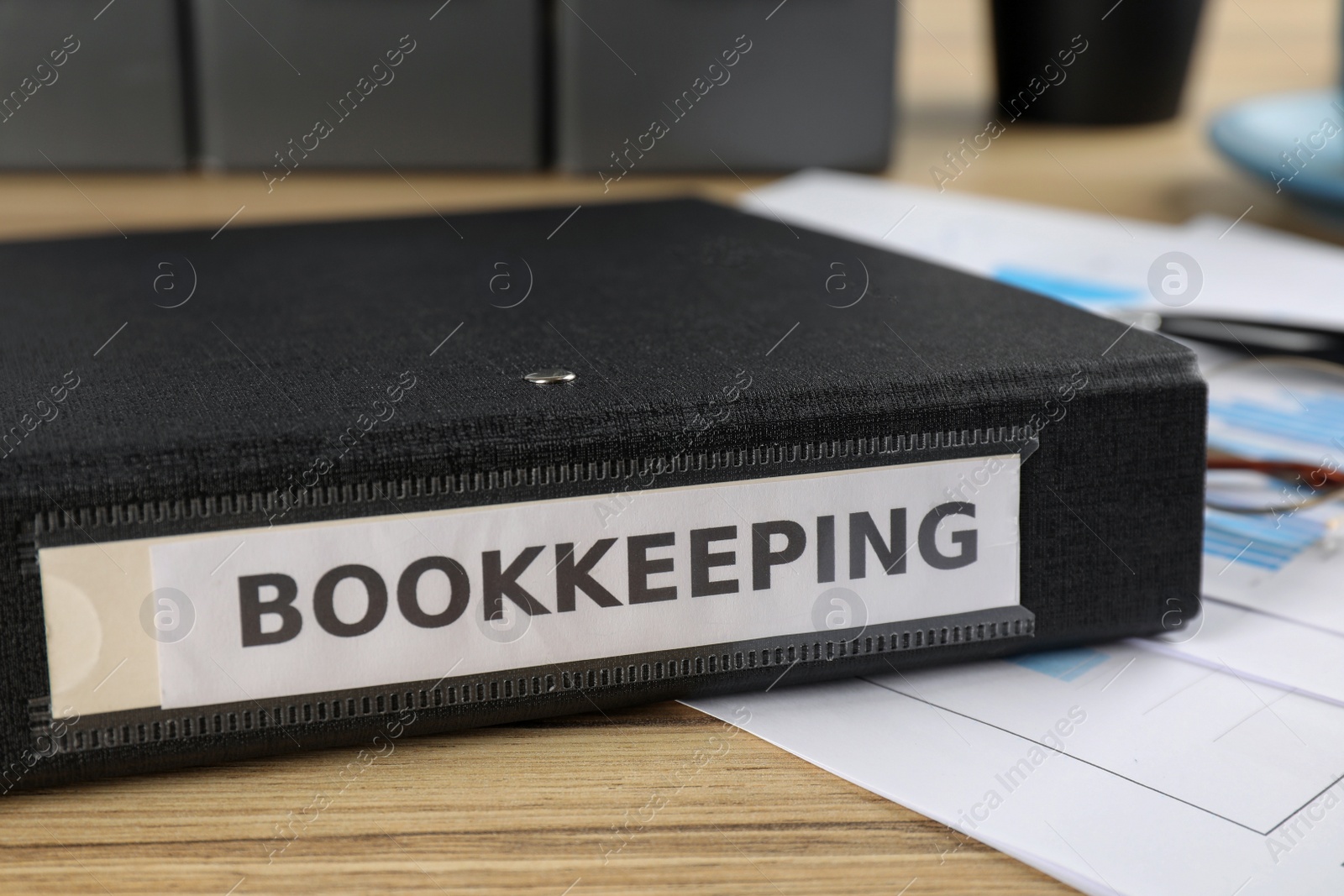 Photo of Bookkeeping folder on desk in office, closeup