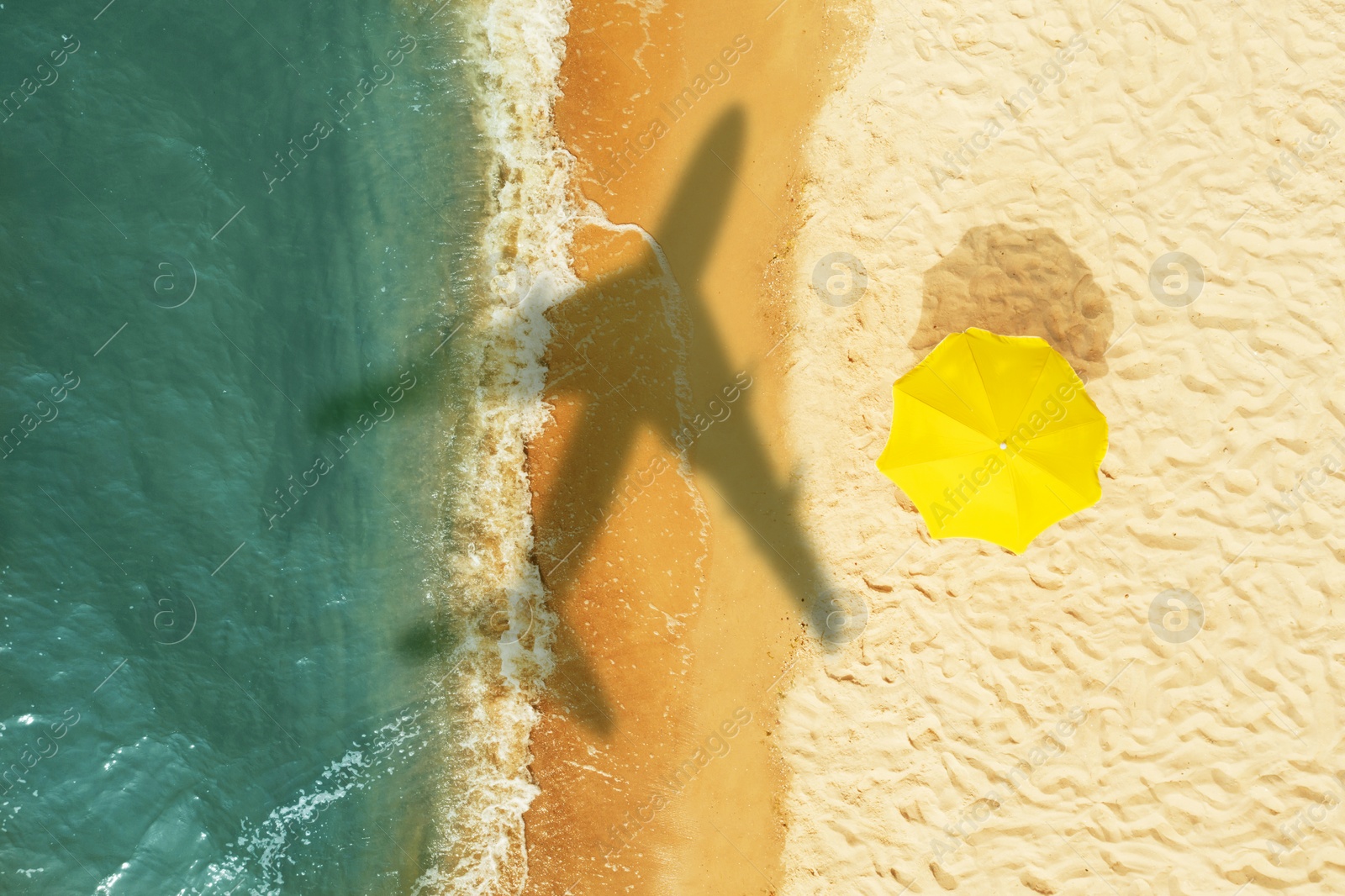 Image of Shadow of airplane above sandy coast, aerial view. Summer vacation