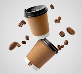 Image of Coffee to go. Paper cups and roasted beans flying on light background