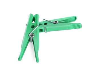 Bright green plastic clothespins on white background