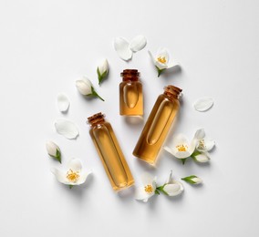 Photo of Jasmine essential and fresh flowers on white background, top view