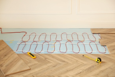 Photo of Installation of electric underfloor heating system indoors