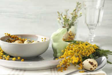 Photo of Festive Easter table setting with beautiful mimosa flowers