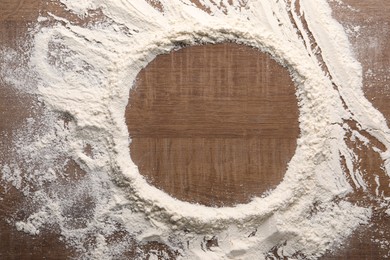 Photo of Imprint of plate on wooden table with flour, top view