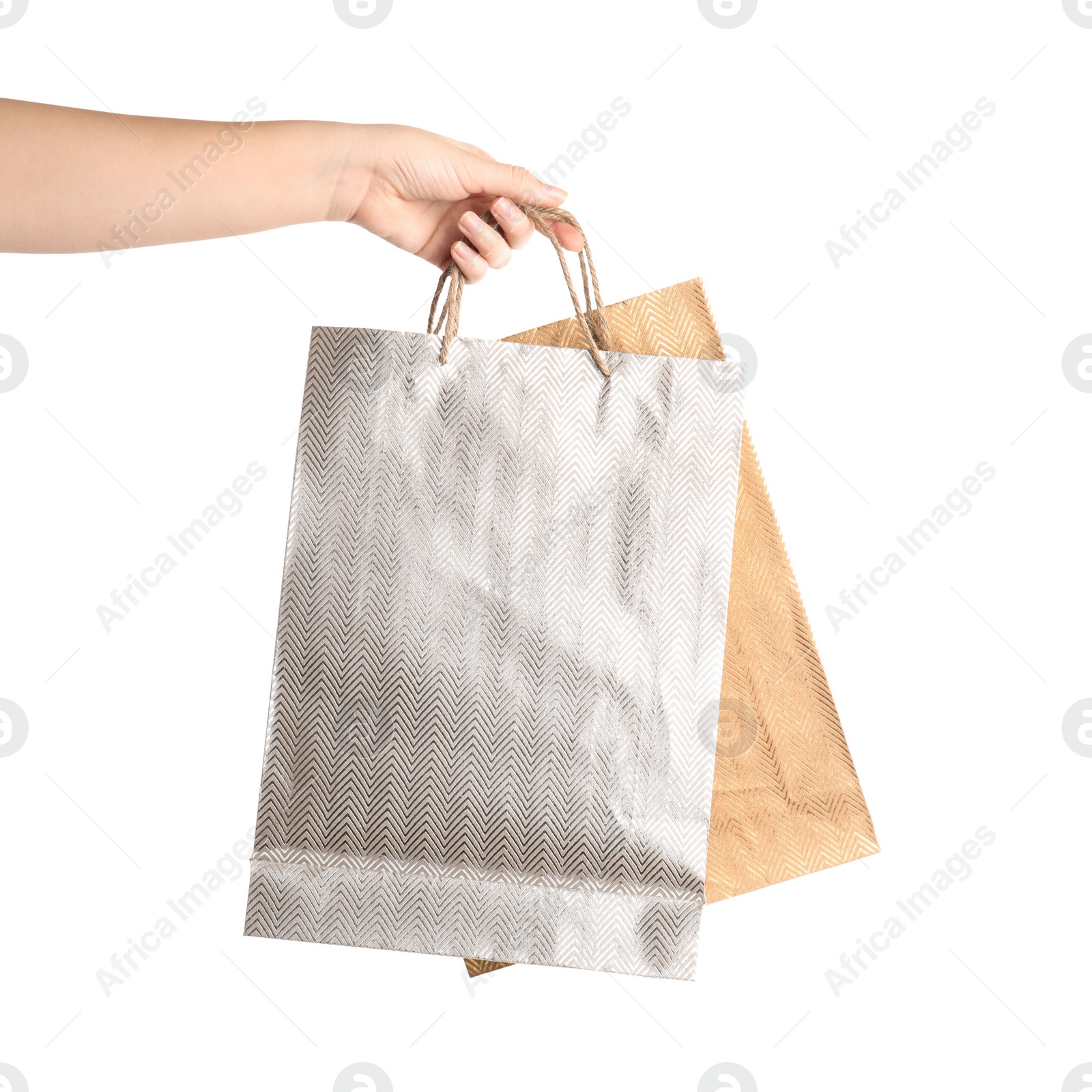 Photo of Woman holding paper shopping bags on white background, closeup. Space for design