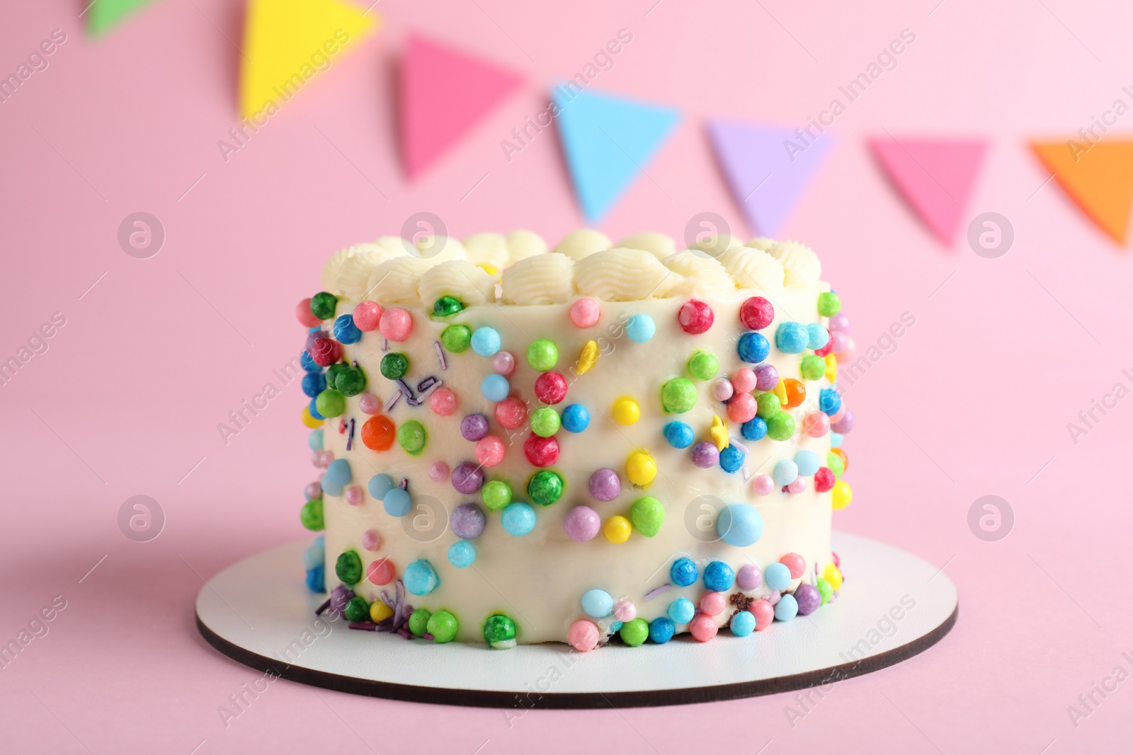 Photo of Cute bento cake with tasty cream on pink background