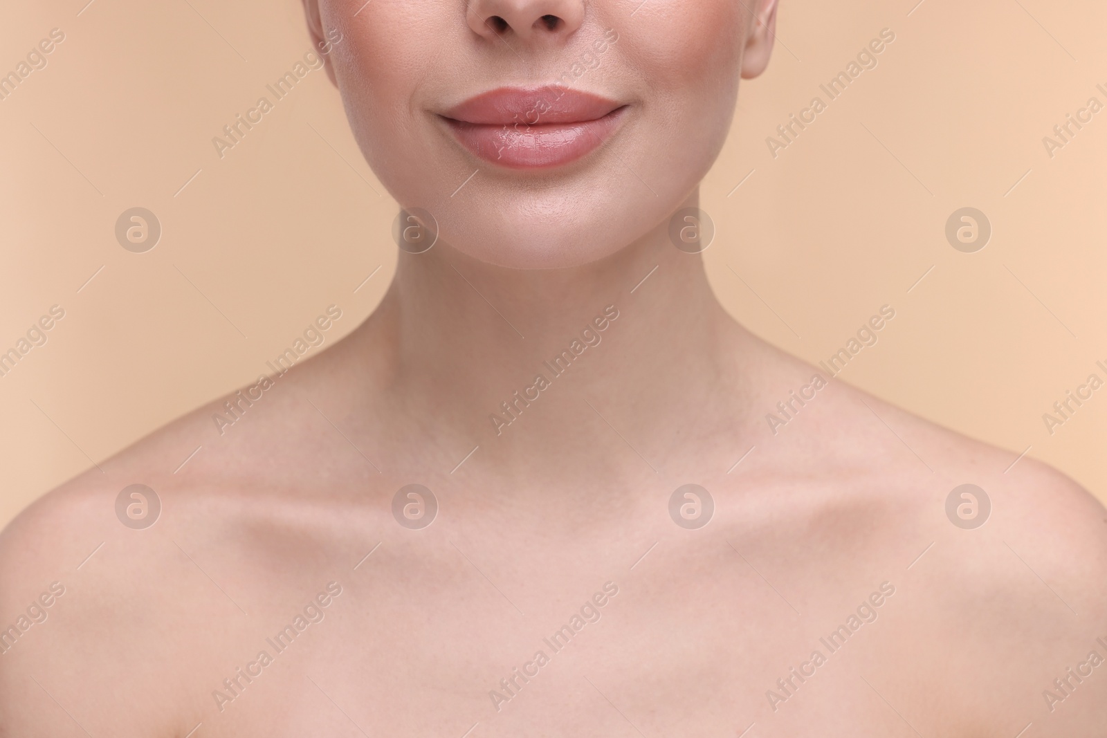 Photo of Woman with beautiful lips on beige background, closeup