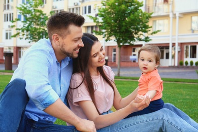 Happy family with adorable little baby outdoors