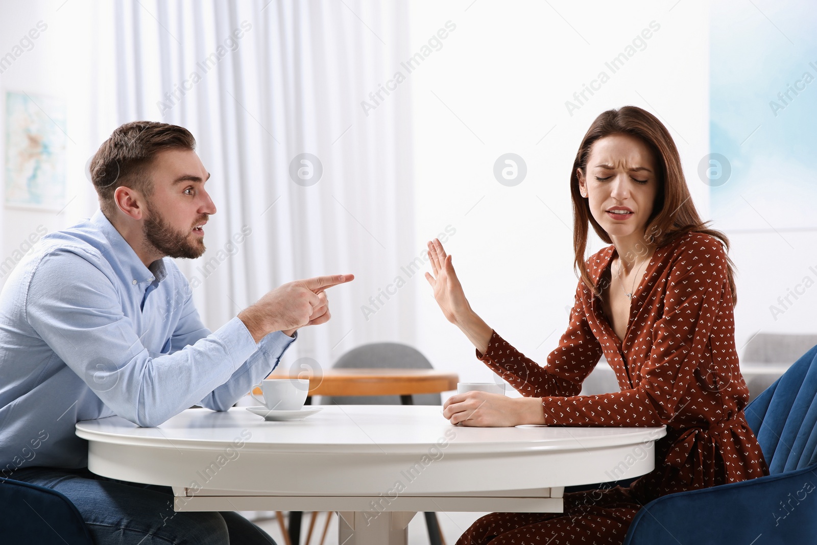 Photo of Couple having quarrel in cafe. Relationship problems