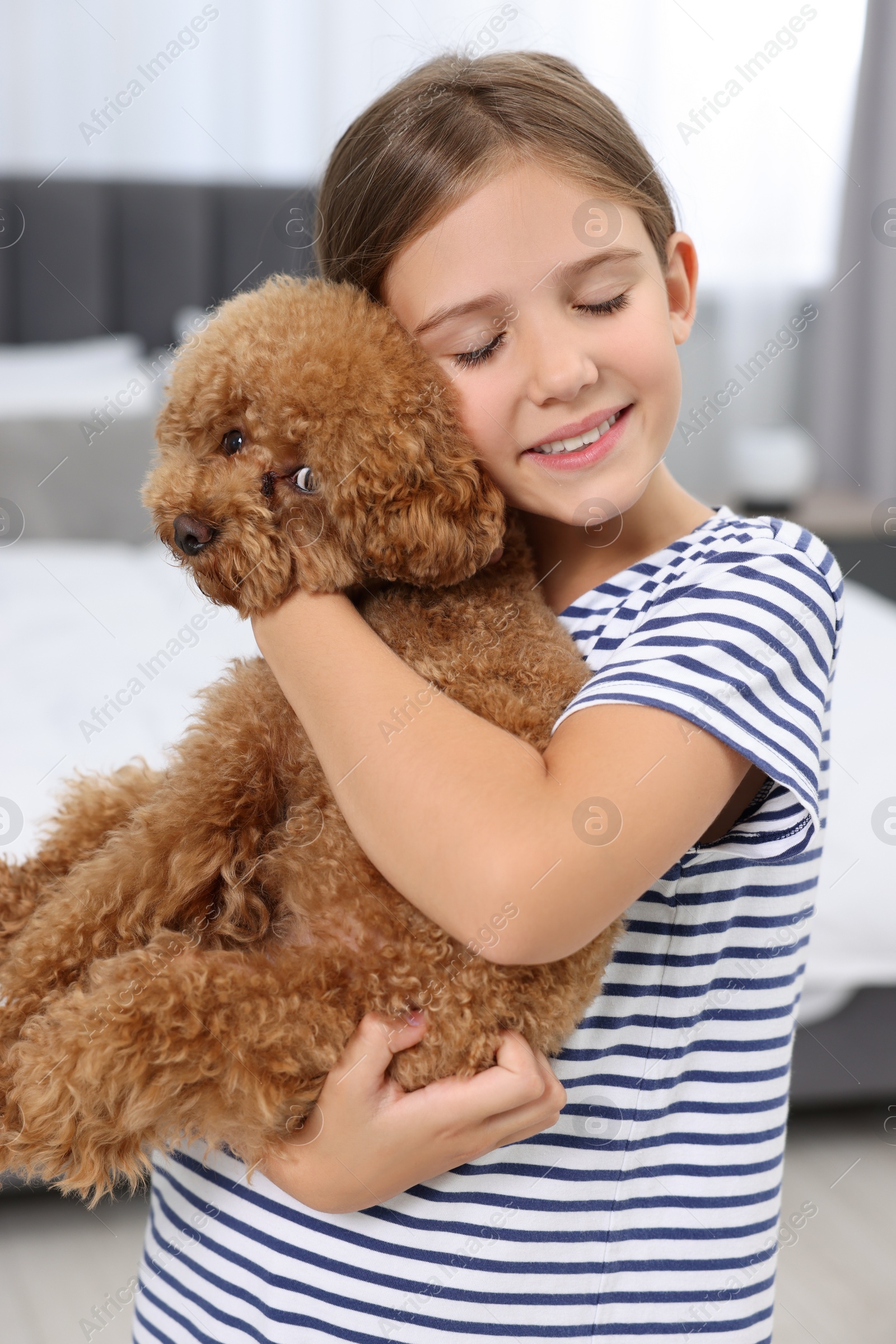 Photo of Little child with cute puppy at home. Lovely pet