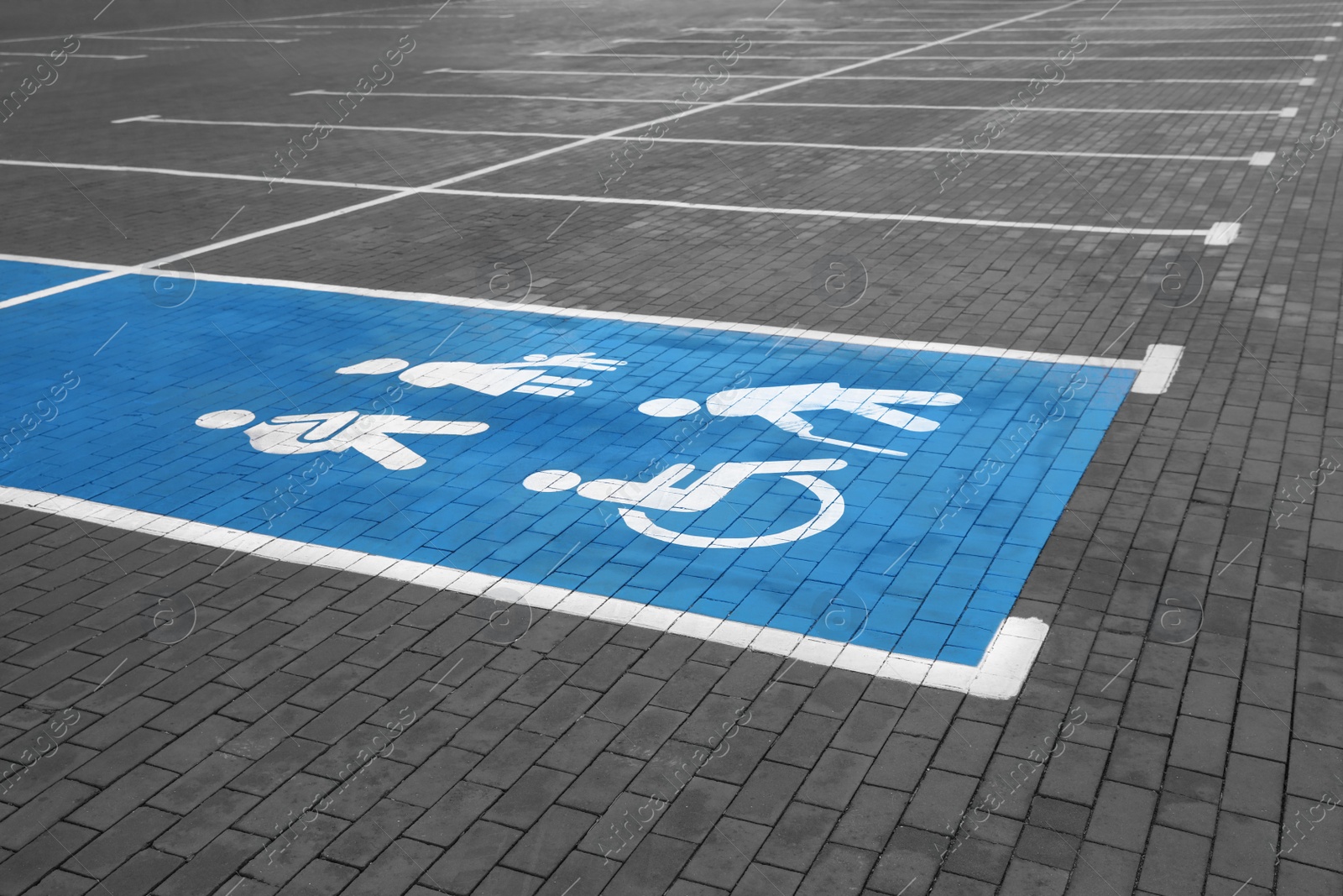 Photo of Empty car parking lot with handicapped symbols outdoors