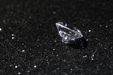 Beautiful dazzling diamond on dark shiny background