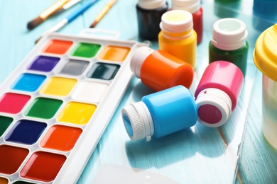 Photo of Set of painting materials for child on color table