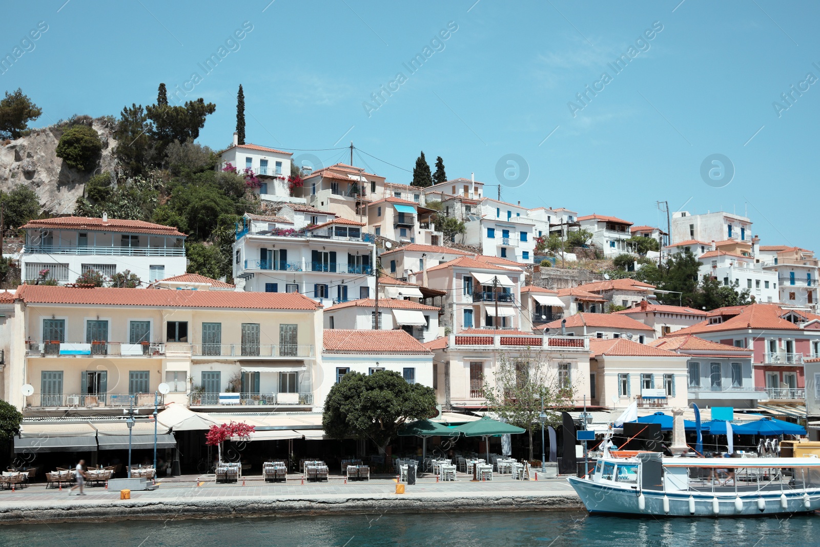 Photo of Beautiful view of coastal city and boat on sunny day