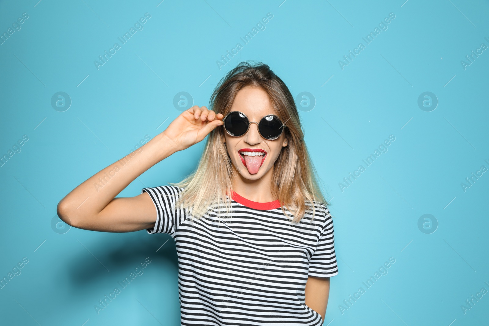 Photo of Beautiful young woman with healthy long blonde hair on color background