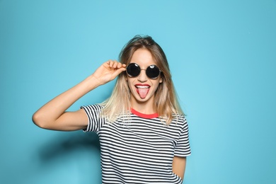 Photo of Beautiful young woman with healthy long blonde hair on color background