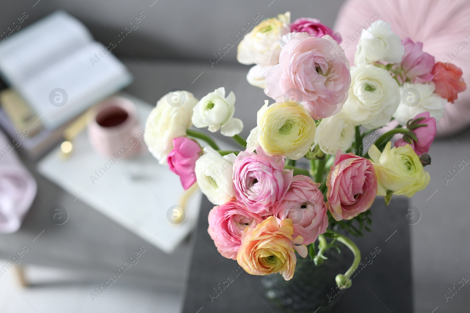 Photo of Bouquet of beautiful ranunculuses in living room