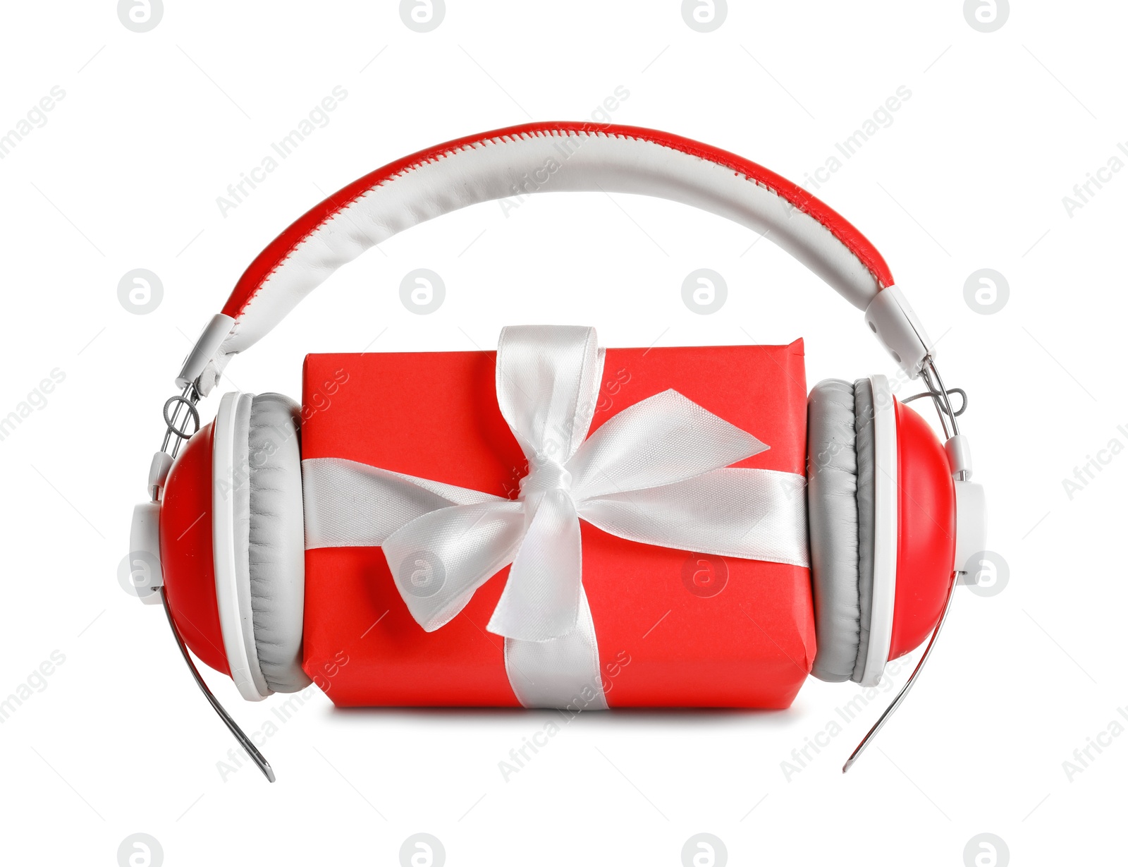 Photo of Gift box with headphones on white background. Christmas music concept