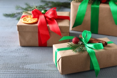 Different wrapped Christmas gifts on wooden table