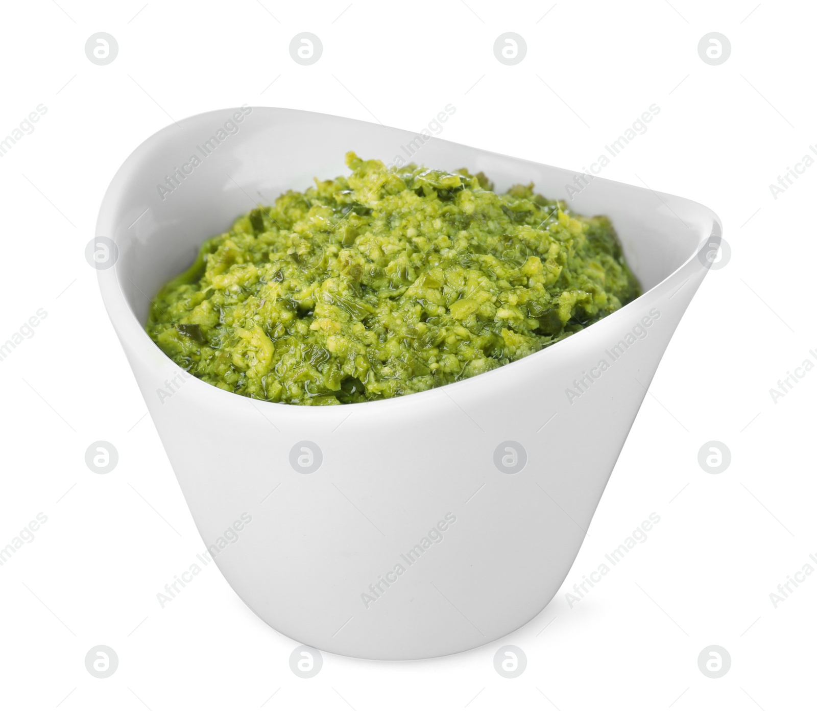 Photo of Bowl of tasty pesto sauce isolated on white