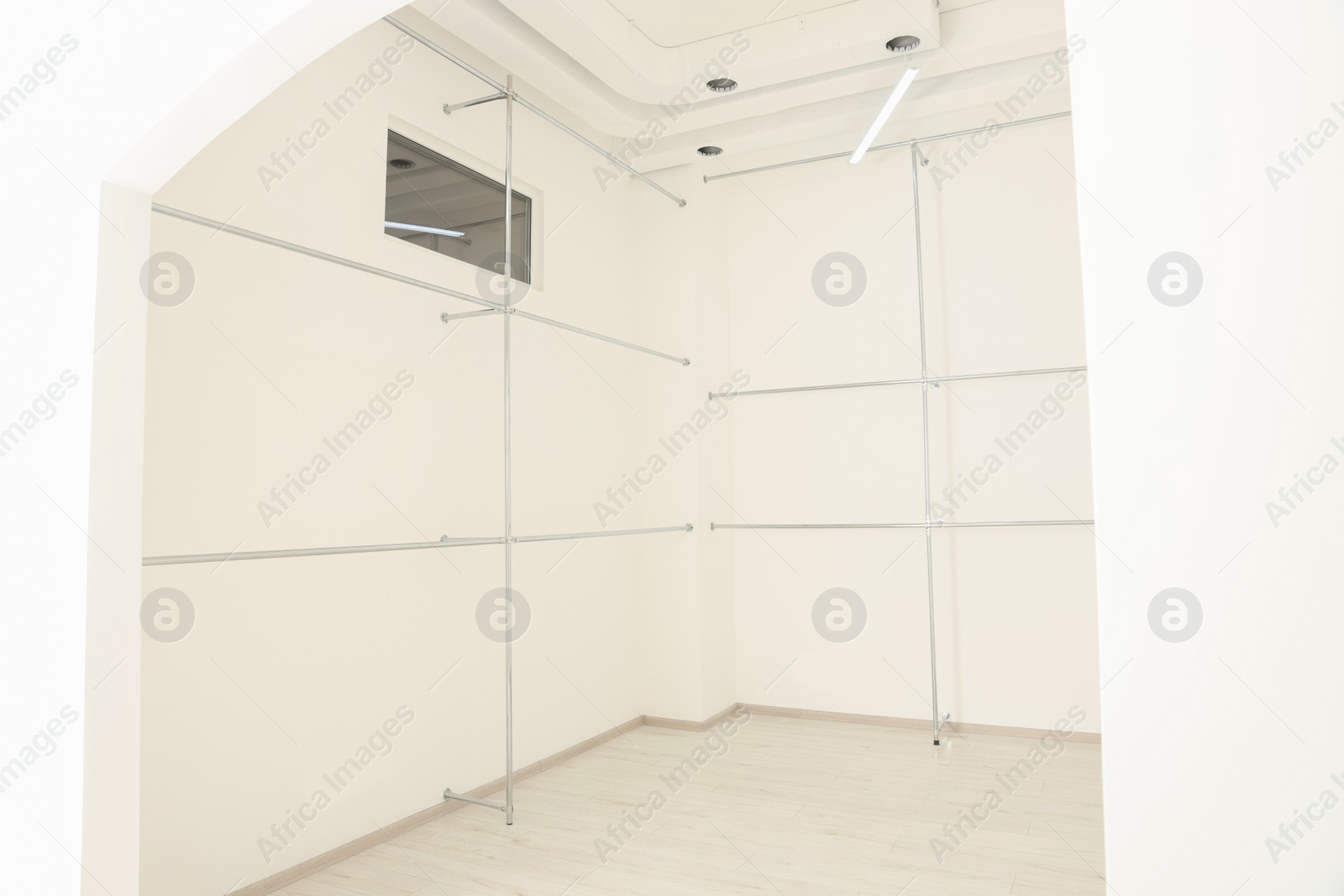 Photo of Metal pipes near white walls in empty office room. Interior design