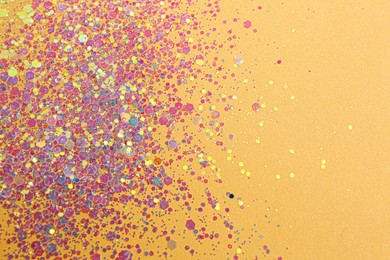 Photo of Shiny bright lilac glitter on beige background. Space for text