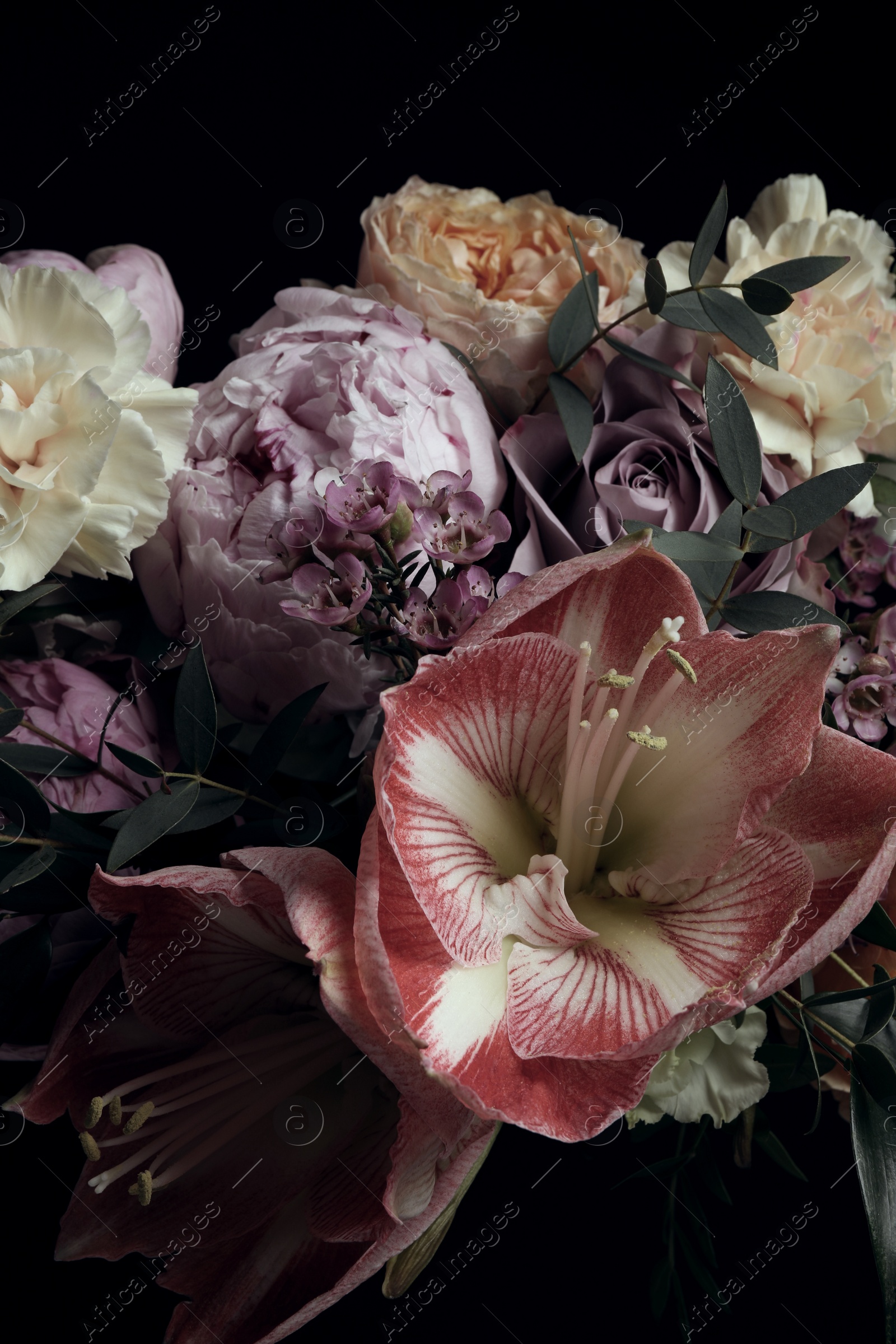 Photo of Beautiful bouquet of different flowers on black background. Floral card design with dark vintage effect