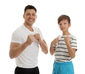 Portrait of sporty dad and his son isolated on white