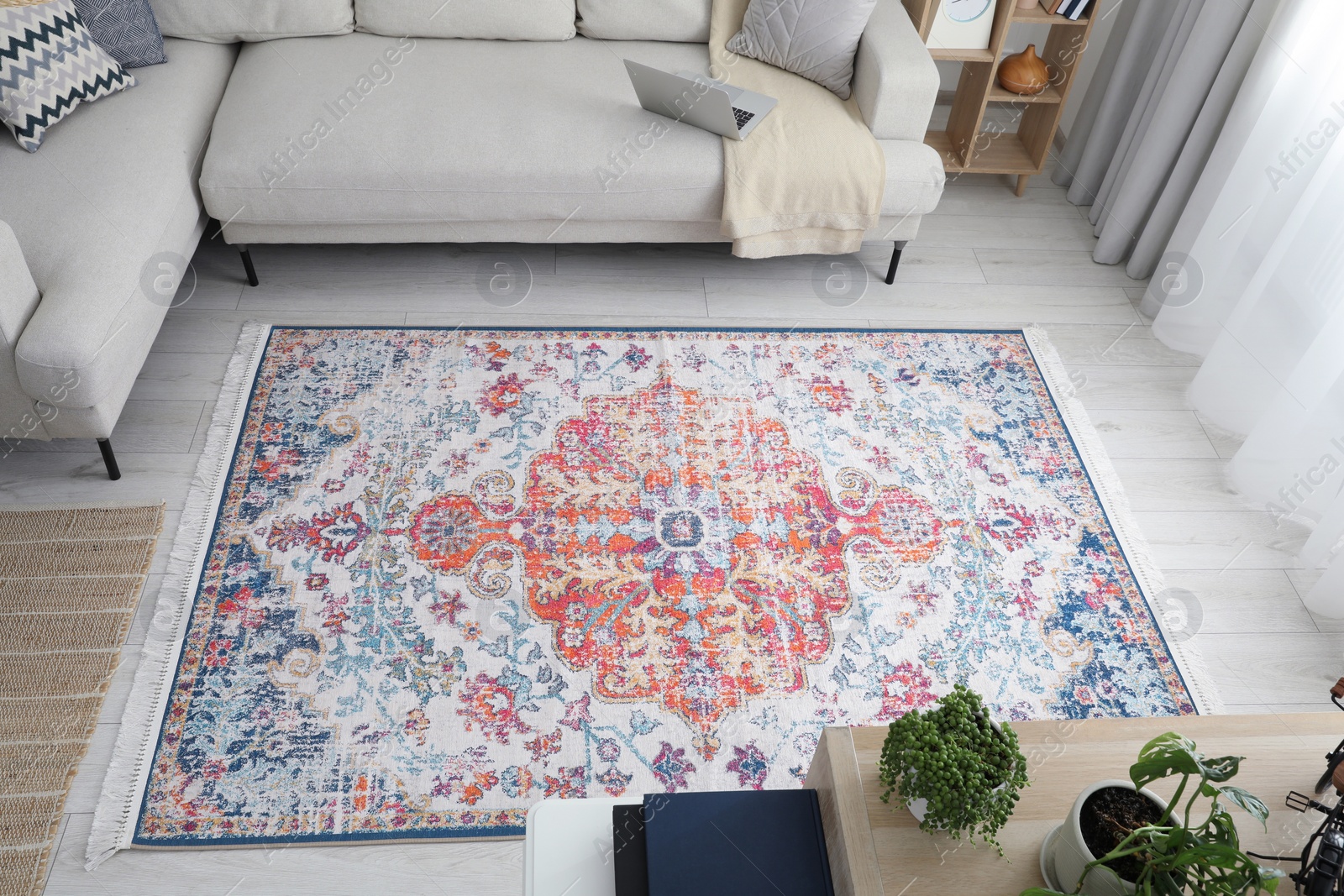 Photo of Stylish living room with beautiful carpet and comfortable sofa, above view. Interior design