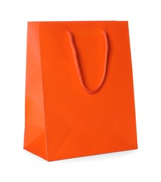 Photo of One orange shopping bag isolated on white