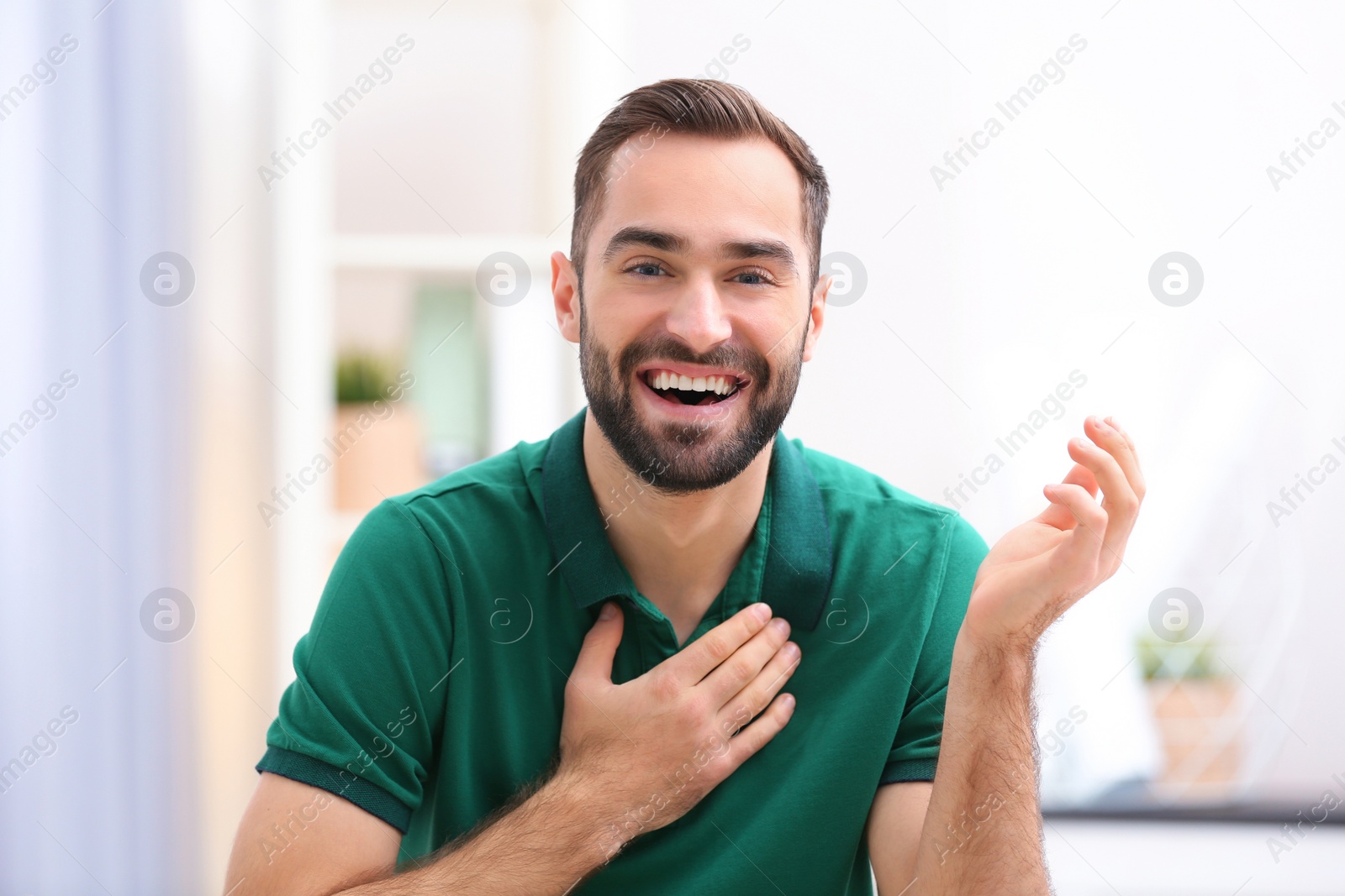 Photo of Handsome man using video chat for conversation indoors