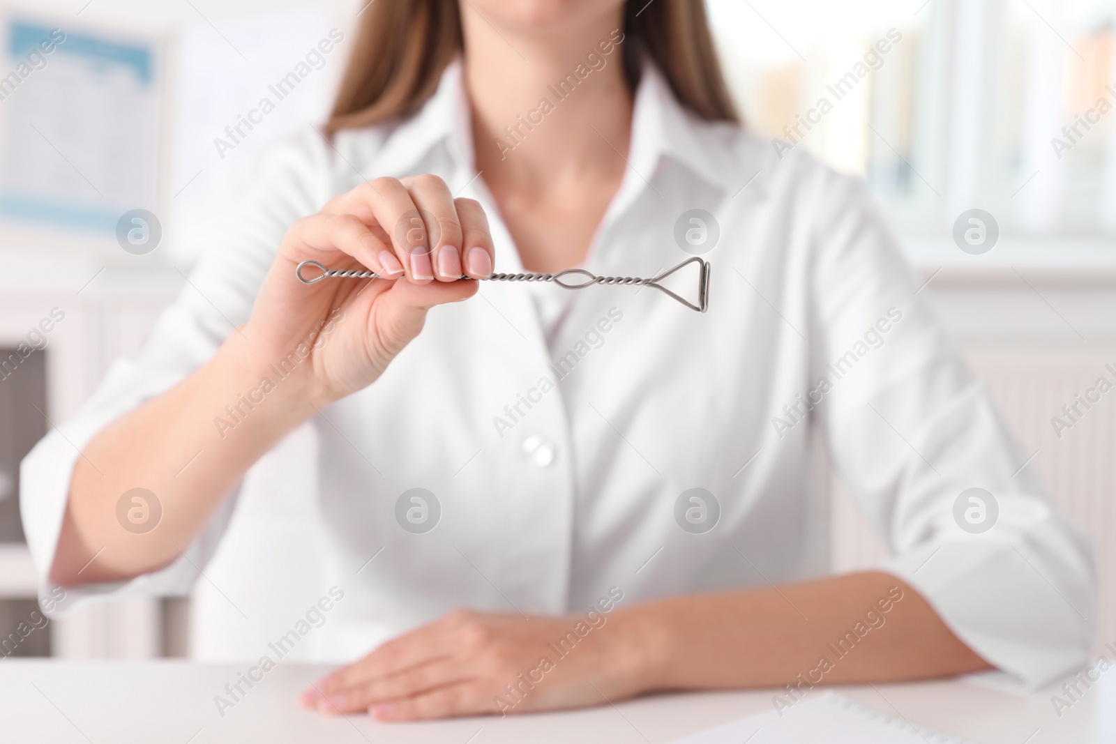 Photo of Speech therapist with logopedic probe in clinic, closeup