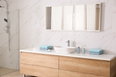 Photo of Modern mirror and vessel sink in stylish bathroom