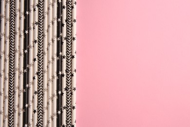 Many paper drinking straws on pink background, flat lay. Space for text