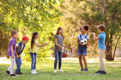 Photo of Cute little children playing with ball outdoors on sunny day