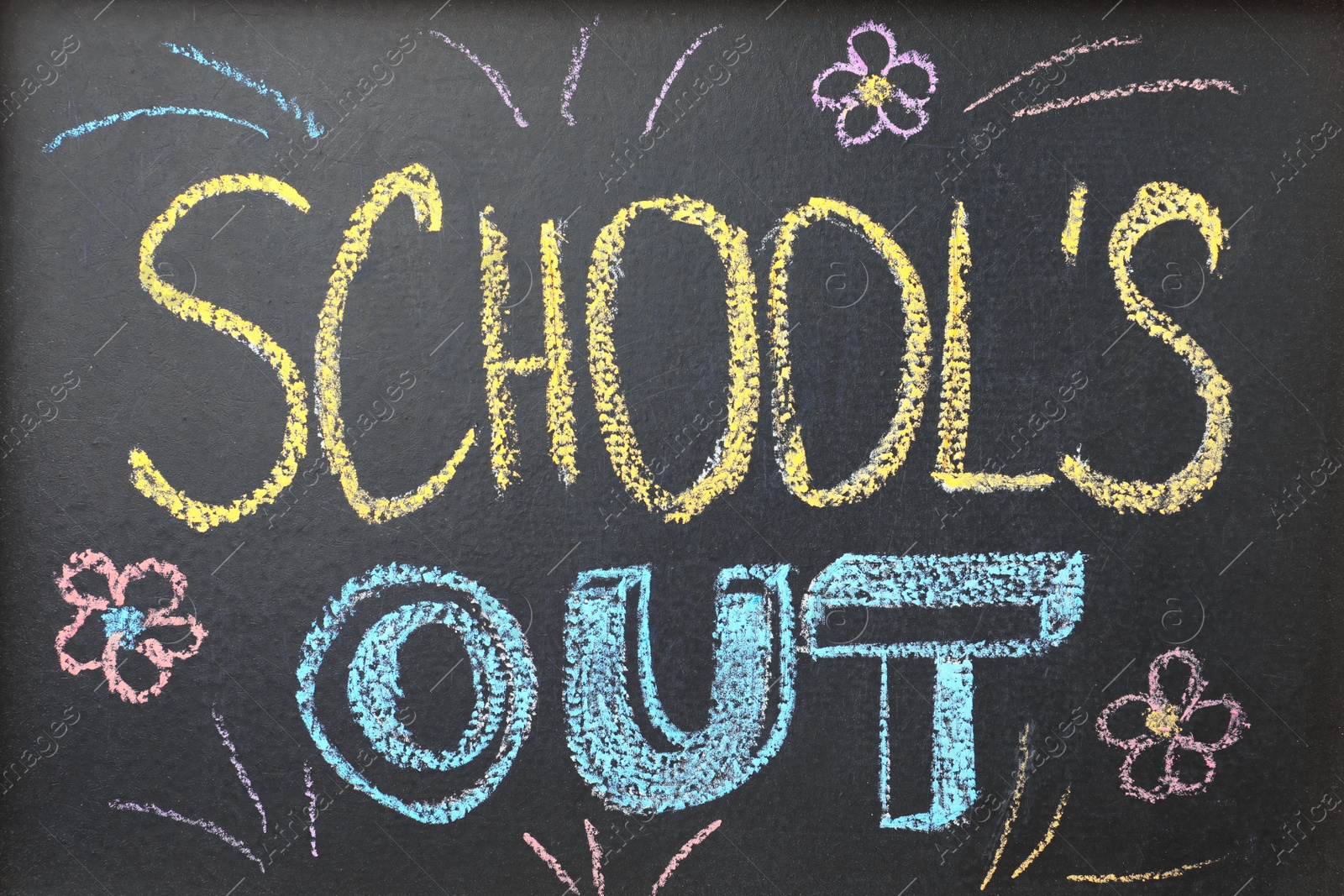 Photo of Text School's Out and drawings on black chalkboard. Summer holidays