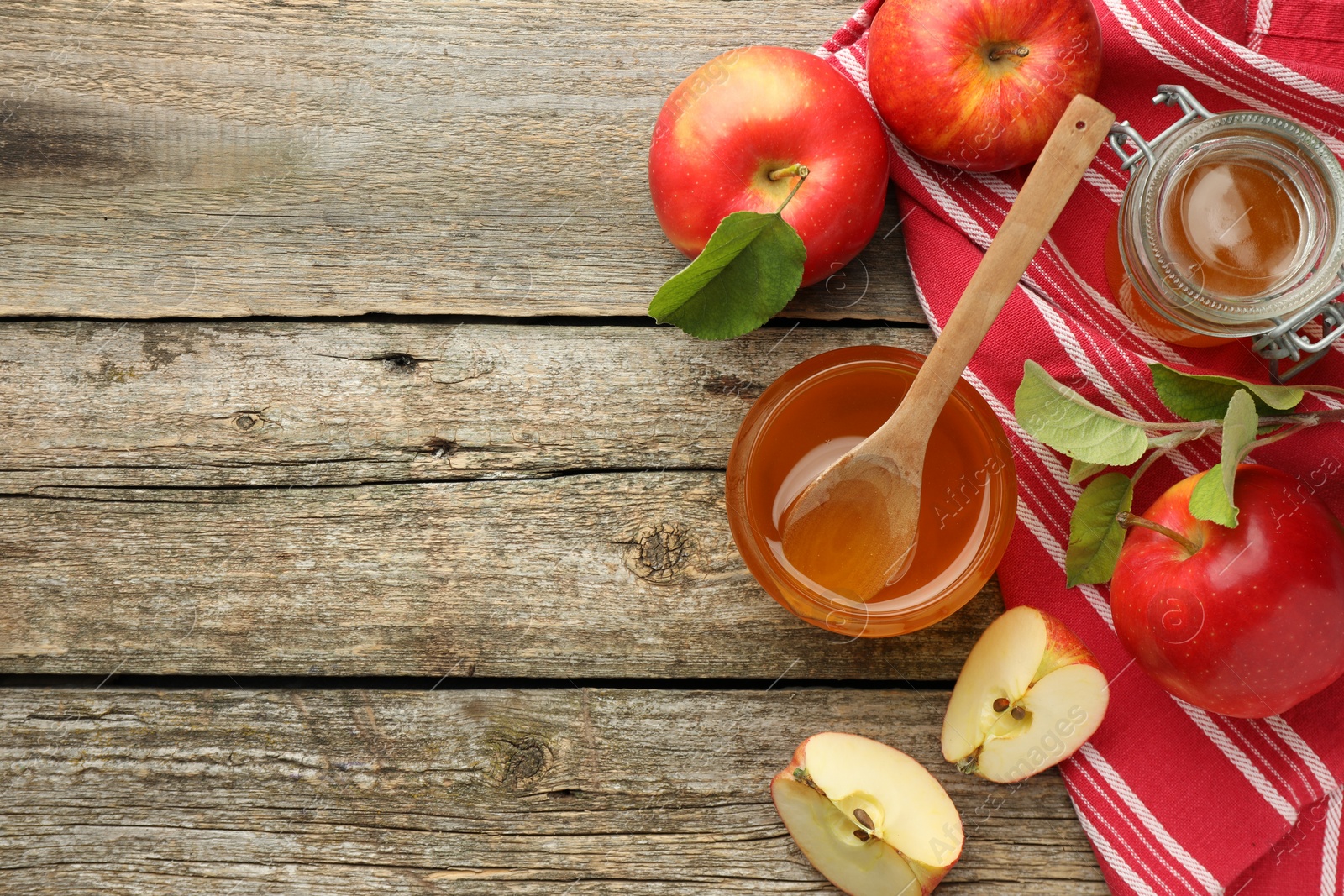 Photo of Sweet honey and fresh apples on wooden table, flat lay. Space for text