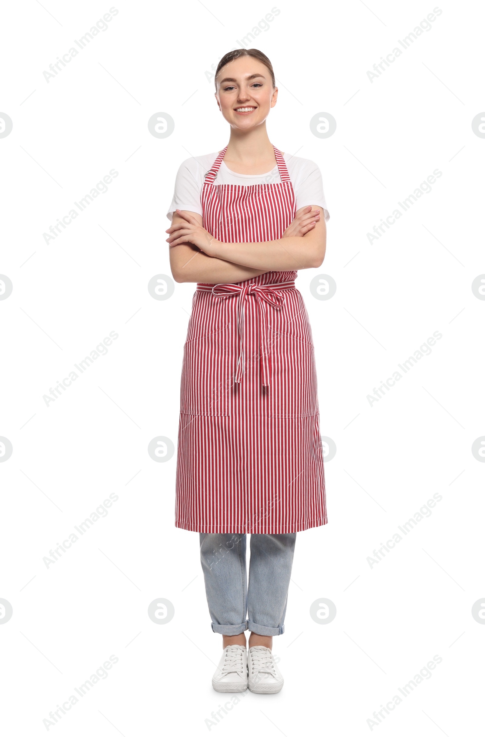 Photo of Beautiful young woman in clean striped apron on white background